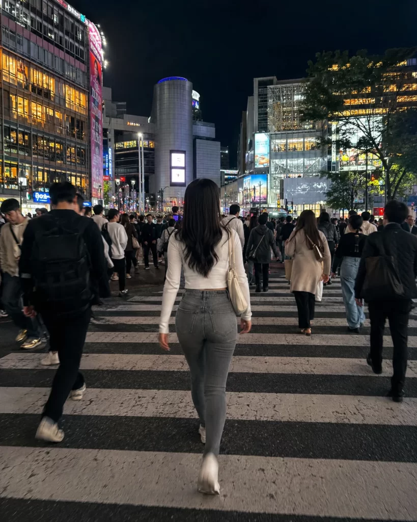 夜の渋谷スクランブル交差点を歩く架空の日本人女性