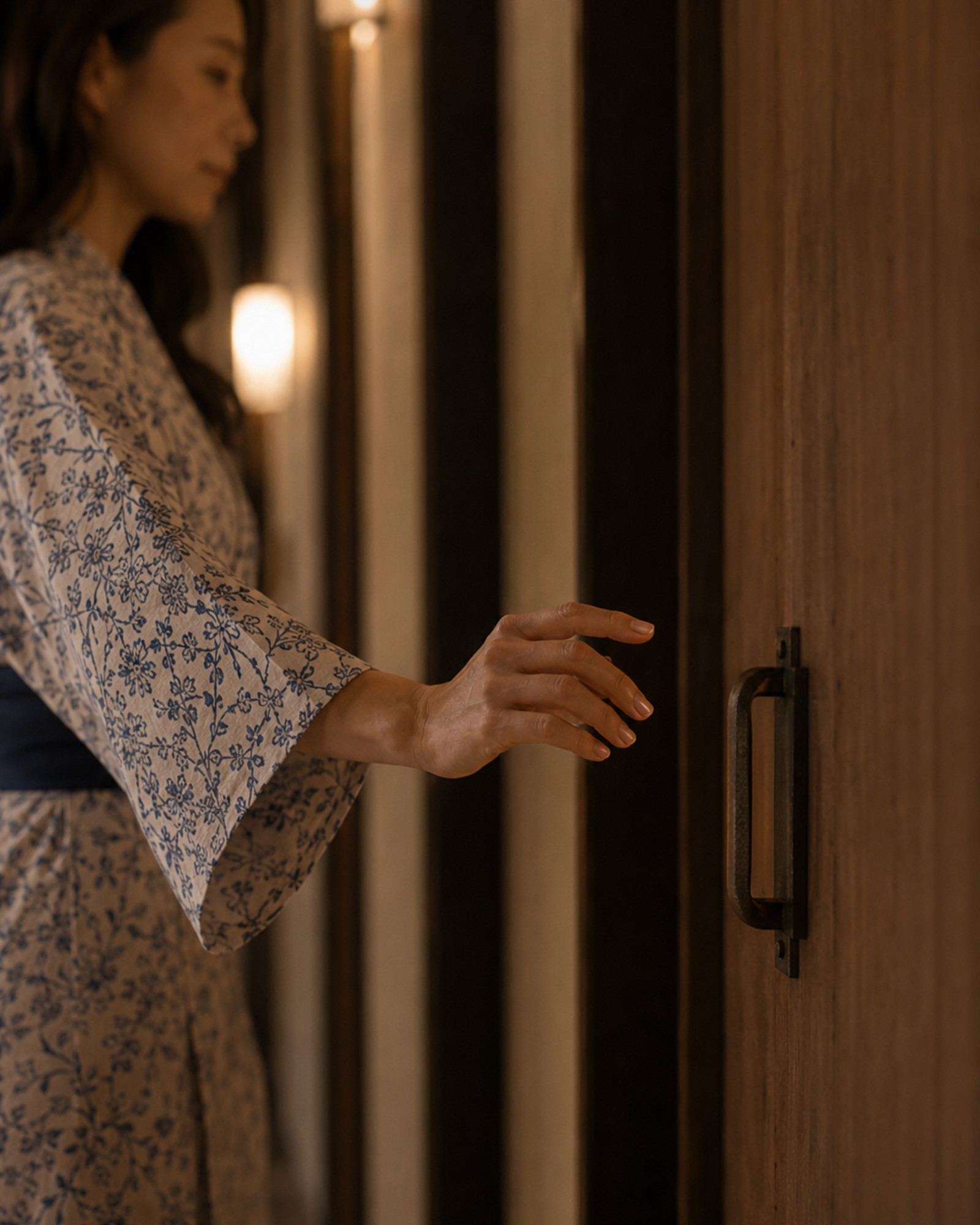 Yoshino Minase in a yukata reaching toward the door of the neighboring room