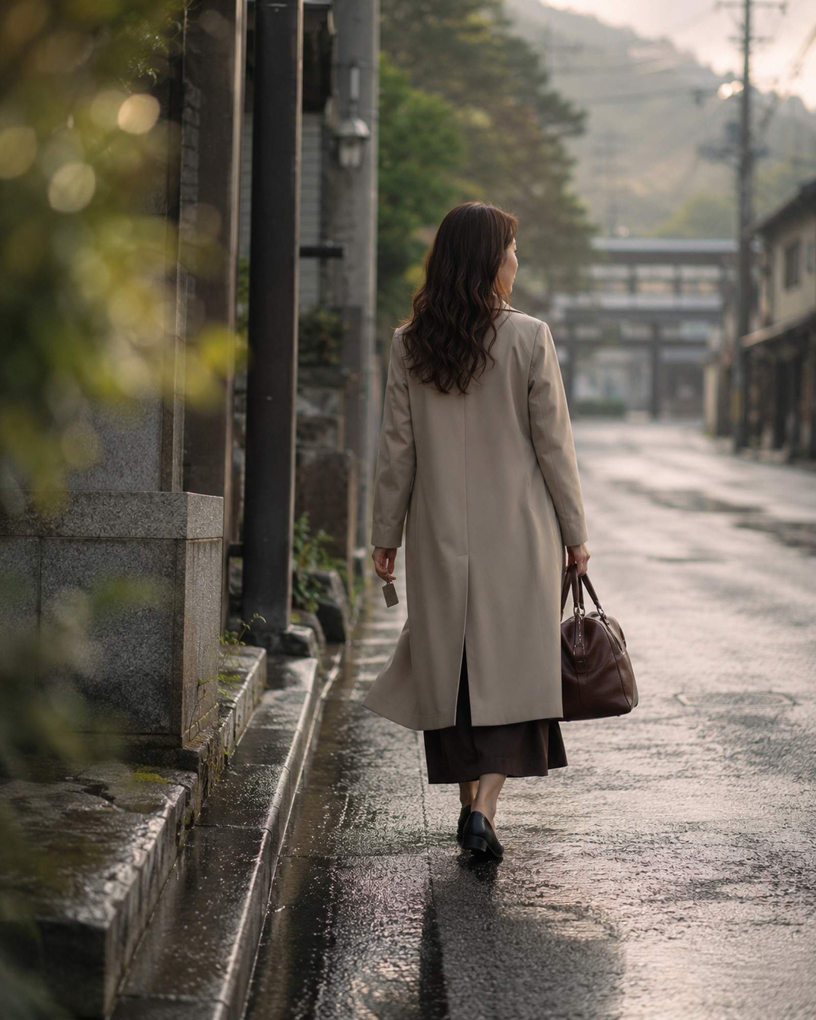 Yoshino Minase walking away through the quiet ryokan town after the rain